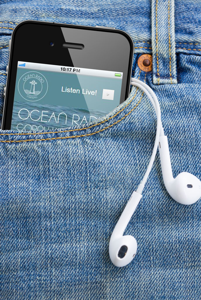 Image showing a smartphone in the pocket of jeans with dangling earbuds.