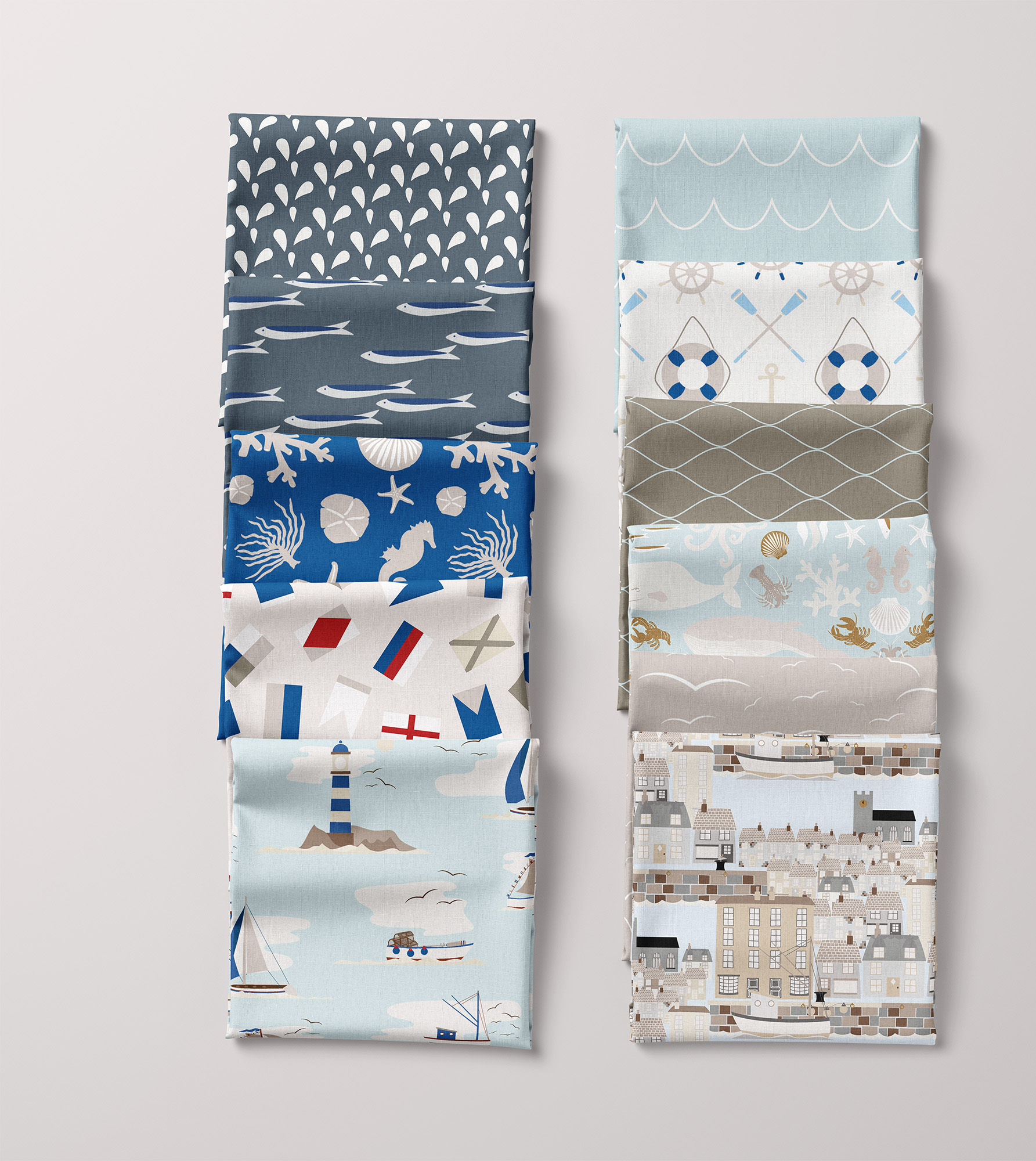 Image of 11 folded fabric squares featuring patterns from Seaweed & Spruce's Quayside pattern collection.