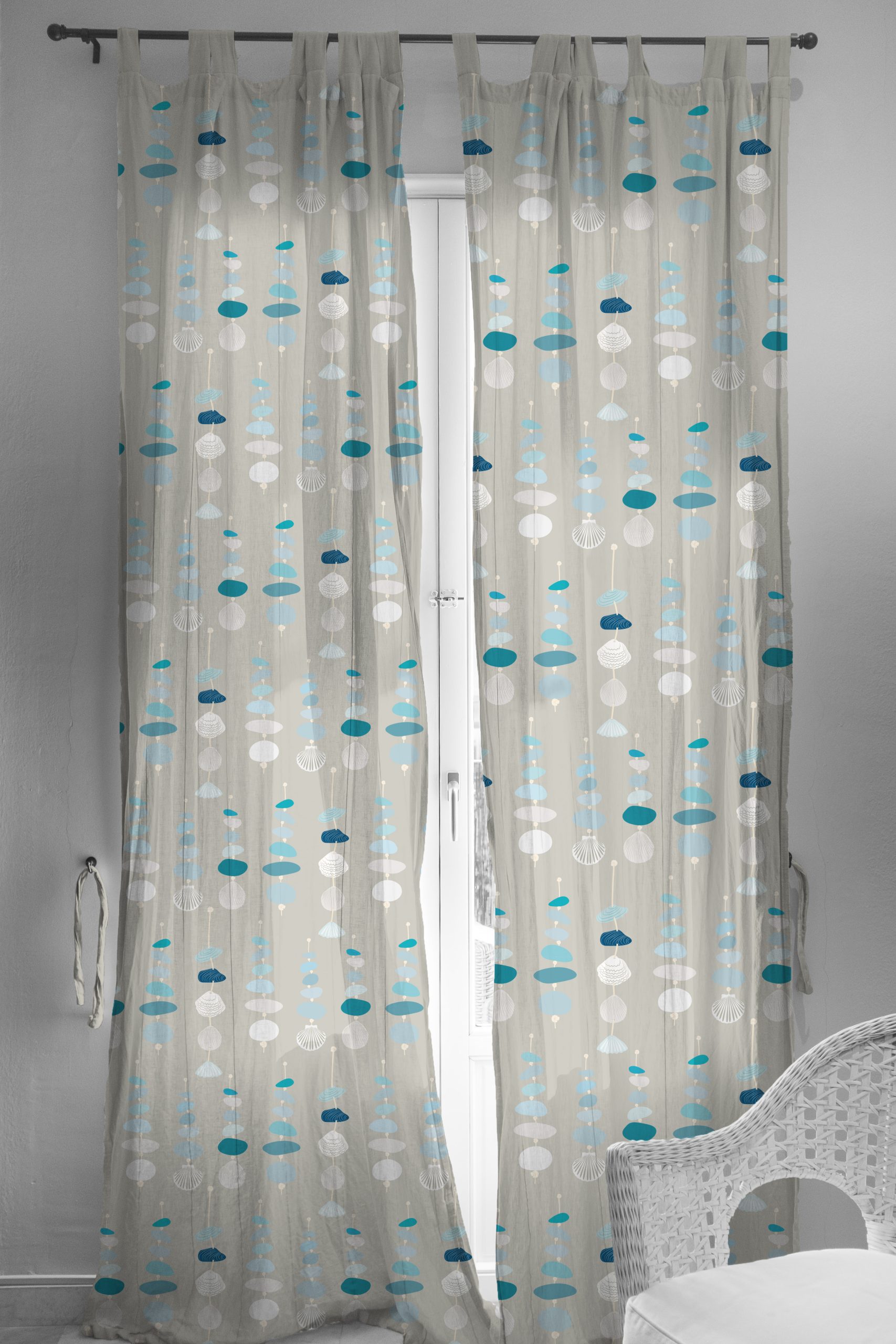 Image shows naturally backlit French doors dressed with long semi sheer voile curtains featuring the Sea Glass Trinkets design from the Sennen collection of patterns.Examples of licensed surface pattern designs on bedding, stationery and homeware.