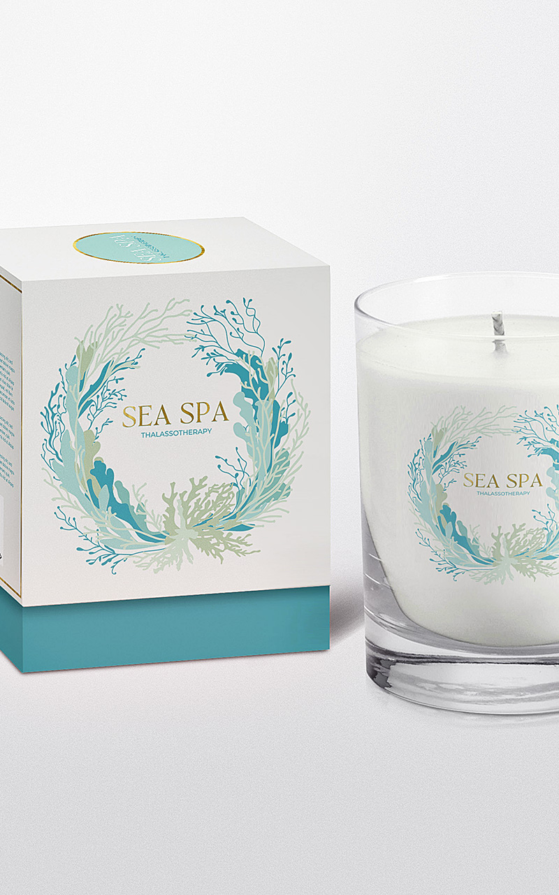 Image of a votive candle and packaging box. The candle's glass container features Sea Spa's (client) logo created by Seaweed & Spruce.