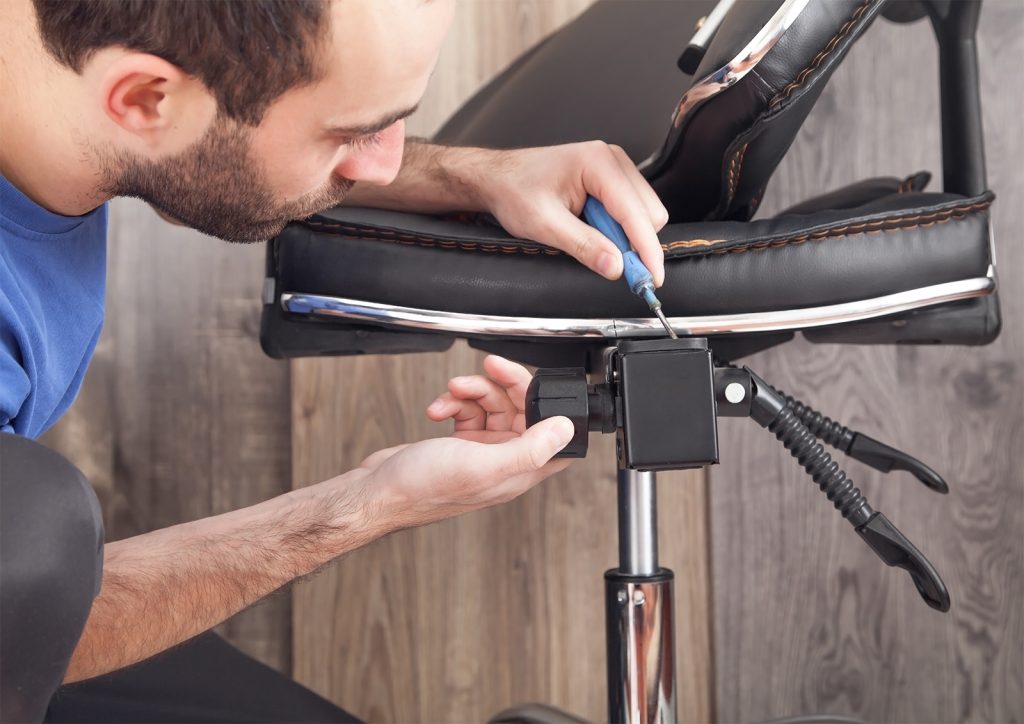 Office Wellness: An image of a man adjusting his office chair.