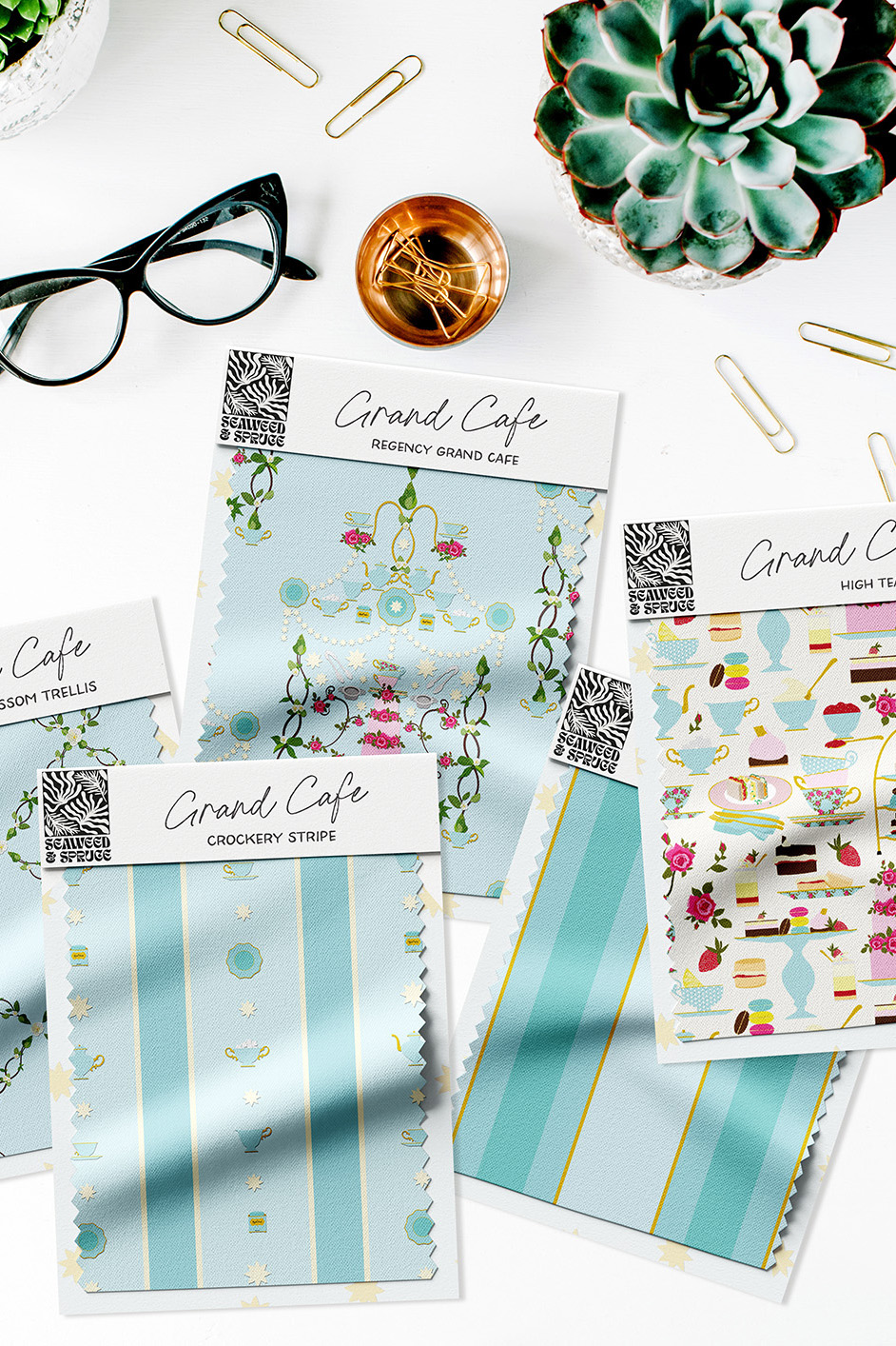 Image of various fabric swatches (attached to branded card) featuring patterns from the Grand Cafe collection.Beautiful surface pattern designs on everyday products like textiles, ceramics and stationery.
